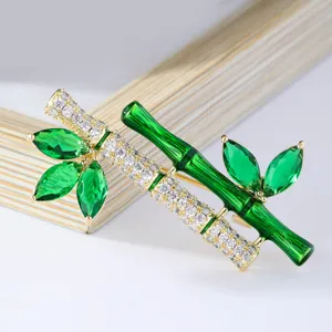 Elegant bamboo brooch with green zircon and clear crystals, luxury designer jewelry accessory