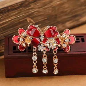 Vintage red butterfly hair claw clip with rhinestones and tassel details for elegant styling.
