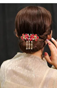 Elegant butterfly hair claw clip with sparkling rhinestones and dangling tassels for women.