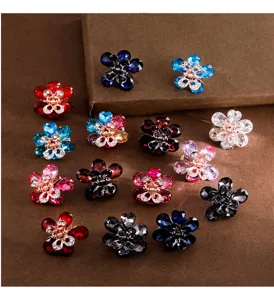Detailed view of small crystal flower hair claws, featuring colorful rhinestones for daily use.