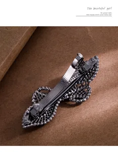Detailed view of the rhinestone bow hair clip, showing sturdy metal spring mechanism.