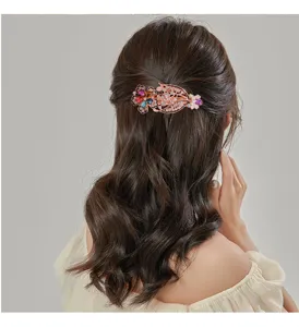 Exquisite rhinestone crystal spring hair clip in rose gold finish, elegant floral design.
