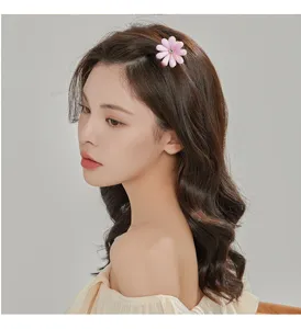 Chic pink flower hair clip with sparkling rhinestone center, elegant side pin for women styling.