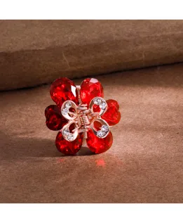 Charming small metal flower hair claw clip with red crystal petals and sparkling rhinestones.