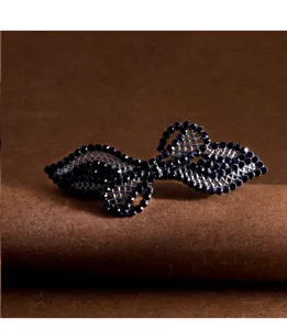 Elegant dark blue rhinestone bow hair clip detail shot, sparkling crystal spring hair barrette.