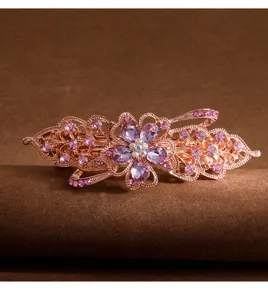 Vintage rhinestone flower hair clip detail, elegant rose gold spring barrette for women.