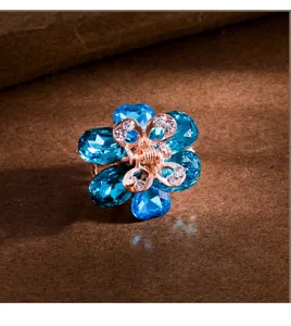 Blue crystal flower hair claw clip, elegant small metal shark clip for cute ponytail styling.