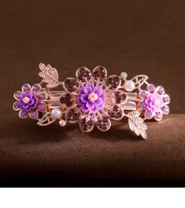 Elegant rose gold crystal hair clip with purple floral details for women's hairstyle.