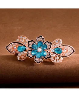 Vintage rhinestone butterfly hair clip detailed shot with blue crystals and alloy base.
