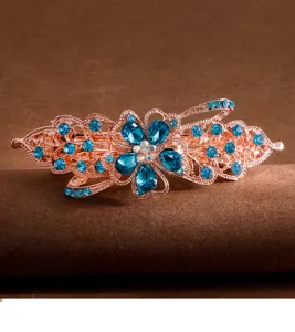 Rose gold tone floral rhinestone spring hair clip detail shot showing blue crystal gems.