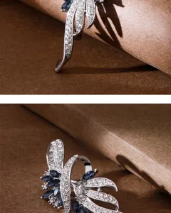 Close-up view of the exquisite rhinestone brooch showing fine crystal and dark blue gem details.
