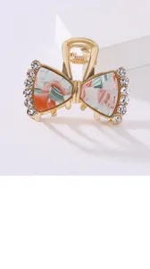 Molletta per capelli a fiocco con strass brillanti e acetato marmo per uno stile elegante.