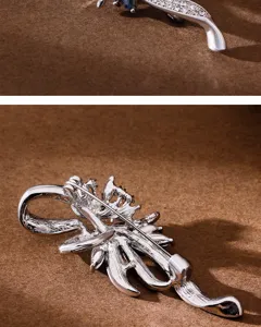 Close-up detail shot of the elegant silver crystal brooch showing the exquisite rhinestone sparkle.