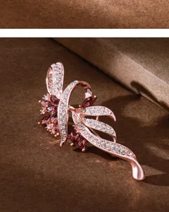 Elegant rose gold crystal brooch with sparkling rhinestones and purple marquise gems for suit.