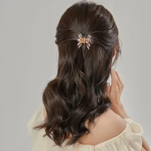 Elegant metal butterfly hair claw clip for women, stylish daily hair styling accessory.