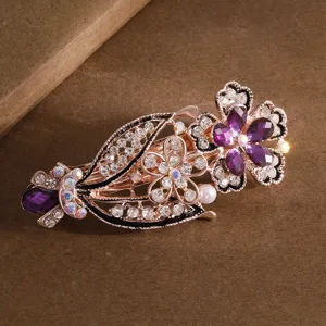 Elegant crystal flower hair clip with sparkling purple rhinestones and secure spring design.