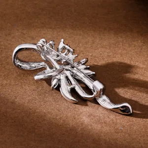 Silver tone brooch pin decorative suit jacket accessory sophisticated elegant classy stylish jewelry.