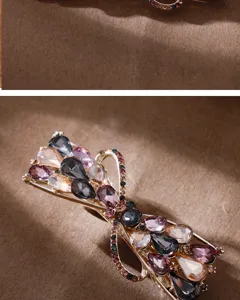 Exquisite rhinestone bow hair clip detail, sparkling crystals on metal barrette, elegant accessory.