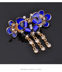 Blue enamel butterfly hair claw clip with elegant rhinestone tassels for women styling.