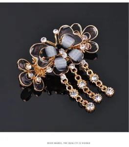 Elegant butterfly hair claw clip with rhinestone tassels and sleek black enamel design.
