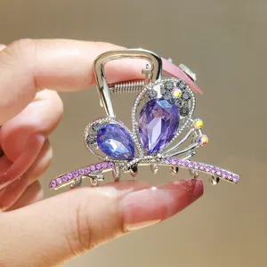 Crystal butterfly hair claw clip with purple rhinestones, elegant metal shark hair accessory.