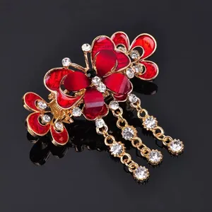 Elegant butterfly hair claw clip with rhinestone tassels and red enamel design for women.