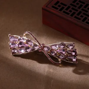 Elegant crystal bow hair clip for women, sparkling rhinestone barrette daily styling.