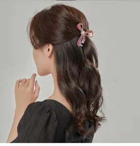 Colorful rhinestone bow hair claw clip for elegant hairstyles, beautiful sparkling crystal hair accessory.