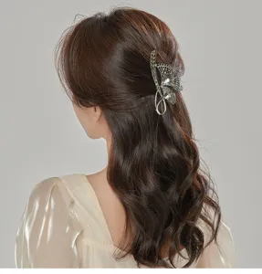Elegant fan-shaped metal hair claw clip with rhinestones, luxury hair accessory style.