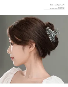 Small metal hair claw clip for women, vintage floral shark clip for stylish updo hairstyles.