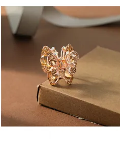 Close-up detail of a charming alloy rhinestone butterfly hair claw clip in elegant gold tone.