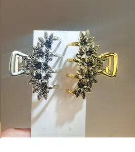 Detail view of Korean style metal hair claw clip with exquisite hollow flower and leaf design.