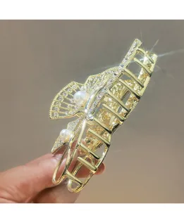 Elegant gold metal hair claw clip featuring fan shape, sparkling rhinestones and pearls.
