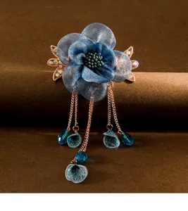 Elegant blue fabric flower hair clip with delicate hanging tassels for vintage styles.