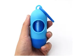 Detailed view of blue portable capsule dog waste bag dispenser with hook and roll.