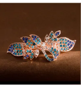 Elegant rhinestone hair clip with blue crystals on rose gold metal for chic hairstyles.