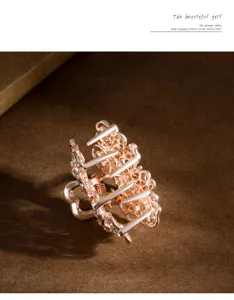 Detail view of a rose gold crystal flower hair claw clip, mini hairpin for elegant styling.