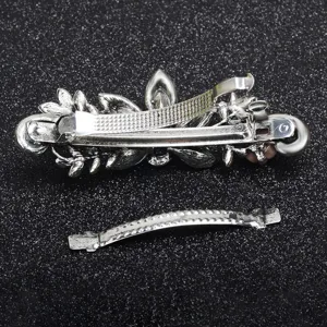 Vintage metal spring hair clip with floral design and rhinestone details for women and girls.