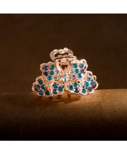 Small crystal flower hair claw clip with sparkling blue rhinestones for elegant styling.