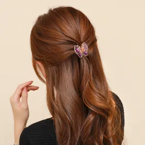 Elegant rhinestone butterfly hair claw clip, sparkly purple crystal metal hair accessory.