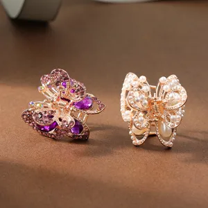 Medium size alloy butterfly hair claw clips set with purple rhinestones and white pearls.