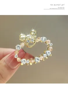 Rhinestone metal hair claw clip, sparkling crystal mini hair accessory detail shot.