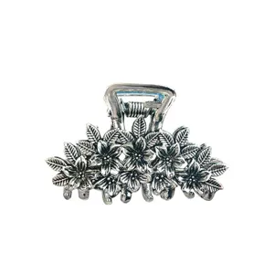 Retro silver metal hair claw clip with exquisite flower and leaf design for women.