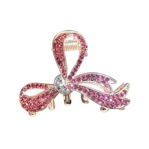 Sparkling rhinestone bow hair claw clip for women, elegant pink crystal hair accessory.