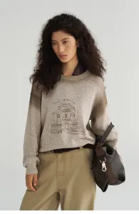 Detailed view of the gradient dyed knit sweater featuring a vintage building sketch graphic.