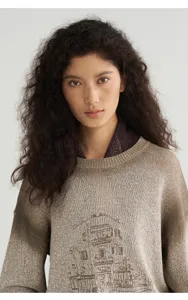 Detail close-up view of brown gradient knitted pullover sweater with architectural line art.