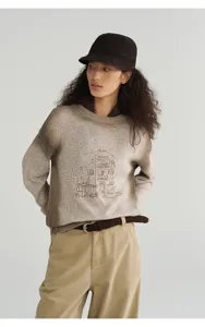 Detailed view of women's gradient knit pullover sweater featuring artistic architectural line art print.
