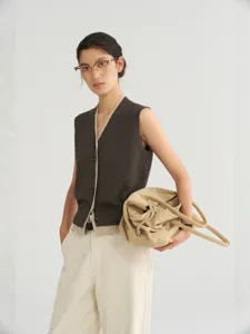 Women's V-neck argyle hollow knit vest, elegant contrast trim sleeveless sweater top main view.