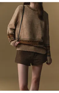 Detail shot of women's chunky Fair Isle knit sweater in winter style, cozy and stylish.