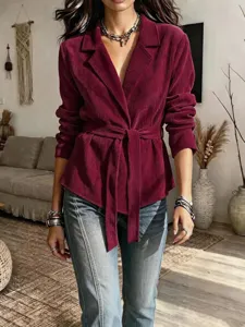 Detailed view of the burgundy corduroy belted blazer, featuring lapel and long sleeves.